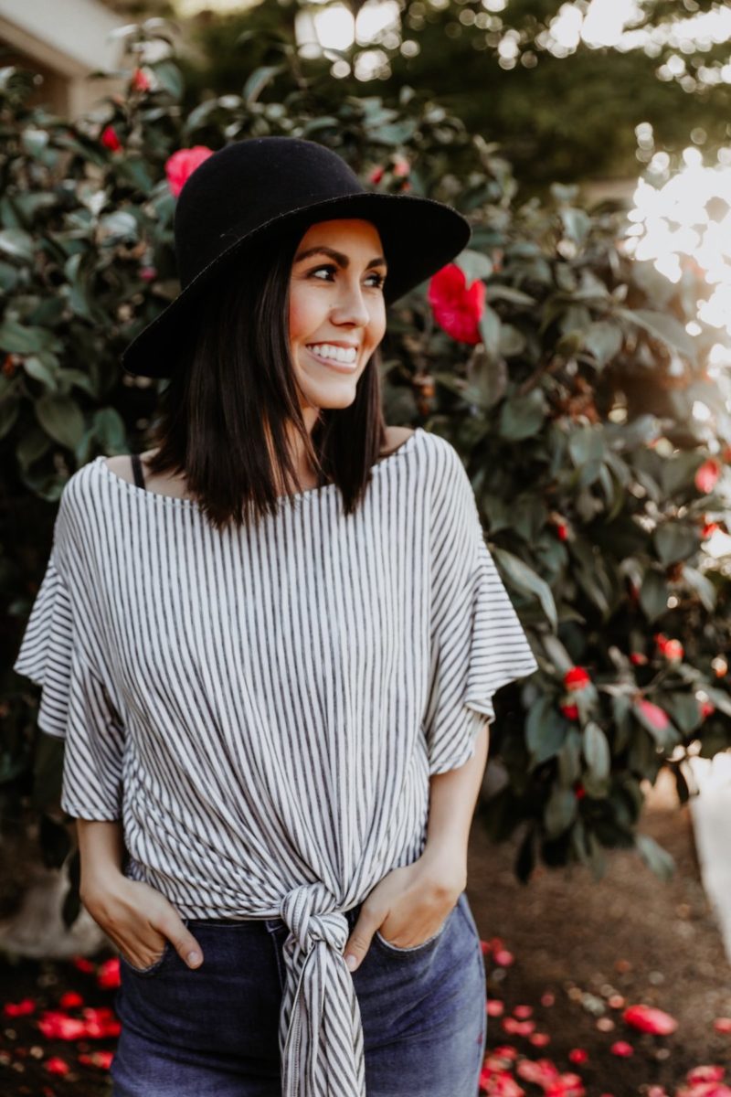 Black hat and striped top.